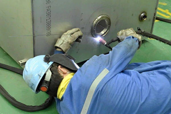the welder is welding lying on the ground